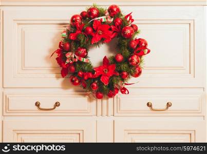 Christmas wreath on the furniture in the room. Home decor. Home decor