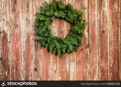 Christmas wreath on the shabby wooden door. Christmas holiday background with copy space