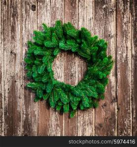 Christmas wreath on the shabby wooden door. Christmas holiday background with copy space. The Christmas wreath