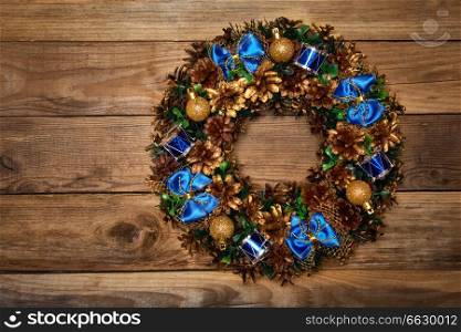 Christmas wreath on wooden background. Christmas wreath top view