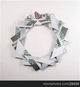 Christmas wreath origami. Christmas wreath origami banknotes on a white background. Handmade