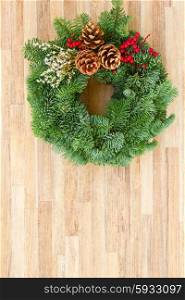 christmas wreath with cones. christmas decorated evergreen wreath on wooden background