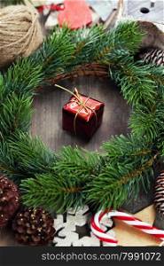 Christmas wreath with decorations on wooden background