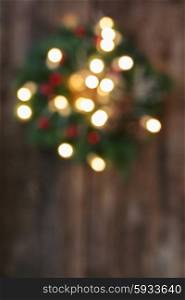 christmas wreath with lights on wood defocused background. christmas wreath with lights defocused background