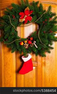 Christmas wreath with red sock on the door