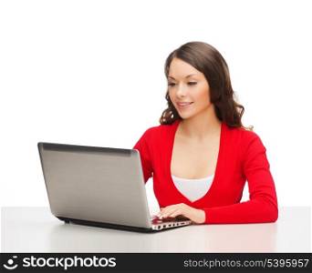 christmas, x-mas, electronics, gadget concept - smiling woman in red clothes with laptop computer