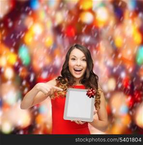 christmas, x-mas, electronics, gadget concept - smiling woman in red dress with blank screen tablet pc