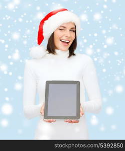 christmas, x-mas, electronics, gadget concept - smiling woman in santa helper hat with blank screen tablet pc