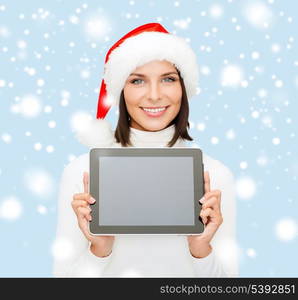 christmas, x-mas, electronics, gadget concept - smiling woman in santa helper hat with blank screen tablet pc