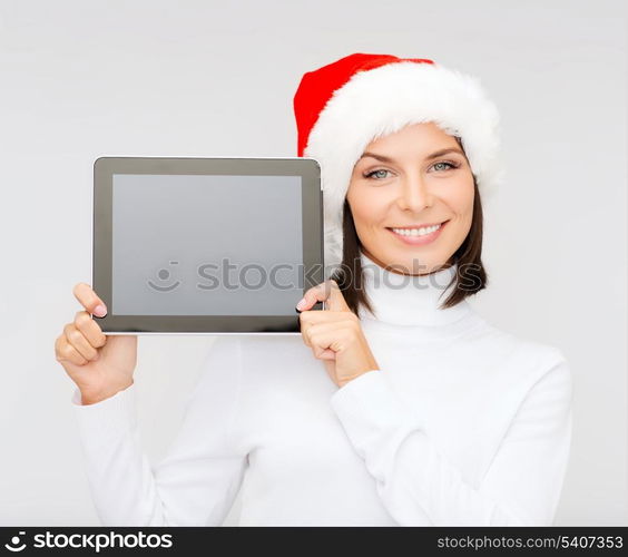 christmas, x-mas, electronics, gadget concept - smiling woman in santa helper hat with blank screen tablet pc