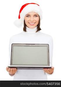 christmas, x-mas, electronics, gadget concept - smiling woman in santa helper hat with blank screen laptop computer