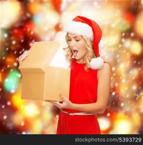 christmas, x-mas, new year, winter, happiness concept - smiling woman in santa helper hat with magic gift box