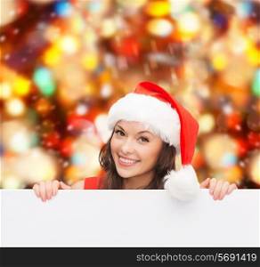 christmas, x-mas, people, advertisement and sale concept - happy woman in santa helper hat with blank white board over red lights background