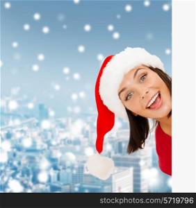 christmas, x-mas, people, advertisement and sale concept - happy woman in santa helper hat with blank white board over snowy city background