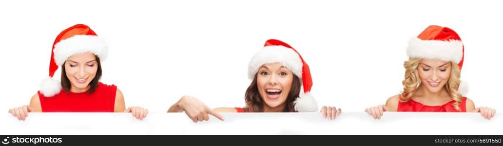 christmas, x-mas, people, advertisement and sale concept - happy women in santa helper hat with blank white board over white background
