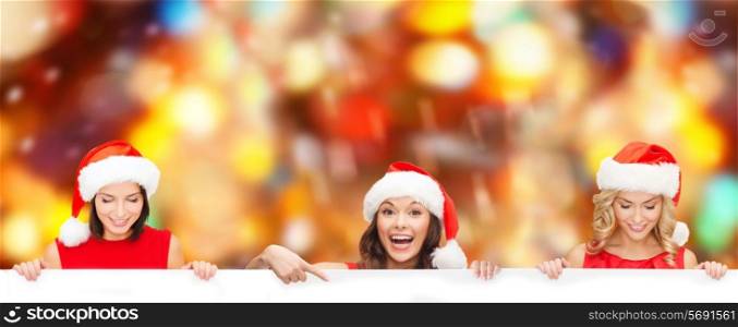 christmas, x-mas, people, advertisement and sale concept - happy women in santa helper hat with blank white board over red lights background