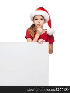christmas, x-mas, people, advertisement, sale concept - happy girl child in santa helper hat with blank white board making shh gesture