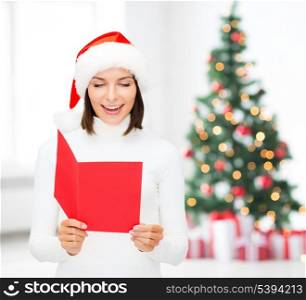 christmas, x-mas, people, advertisement, sale concept - happy woman in santa helper hat with blank red postcard