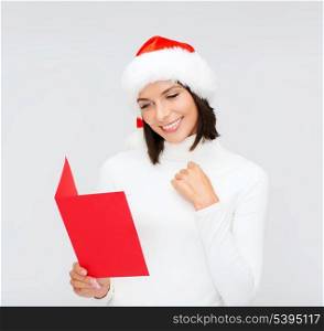 christmas, x-mas, people, advertisement, sale concept - happy woman in santa helper hat with blank red postcard