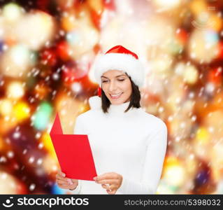 christmas, x-mas, people, advertisement, sale concept - happy woman in santa helper hat with blank red postcard