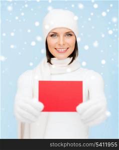 christmas, x-mas, people, advertisement, sale concept - happy woman in winter clothes with blank red card