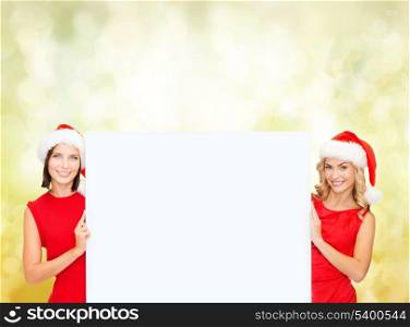christmas, x-mas, people, advertisement, sale concept - happy women in santa helper hats with blank white board