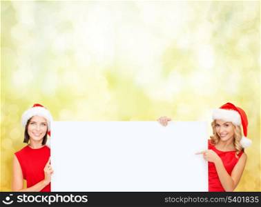 christmas, x-mas, people, advertisement, sale concept - happy women in santa helper hats with blank white board
