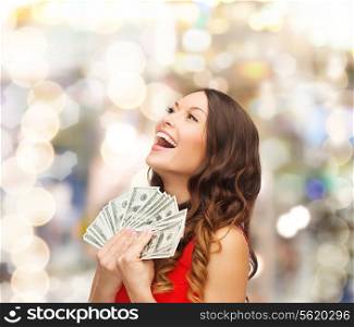 christmas, x-mas, sale, banking and holidays concept - smiling woman in red dress with us dollar money