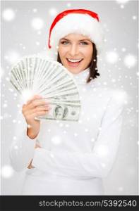 christmas, x-mas, sale, banking concept - smiling woman in santa helper hat with us dollar money