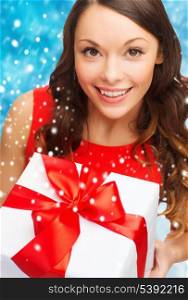 christmas, x-mas, valentine&#39;s day, celebration concept - smiling woman in red dress with gift box