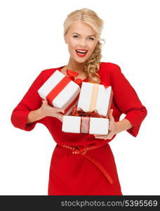 christmas, x-mas, valentine&#39;s day, celebration concept - smiling woman in red dress with many gift boxes