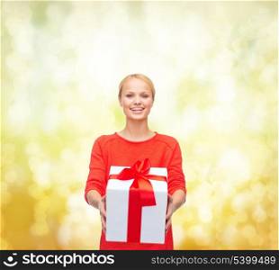christmas, x-mas, valentine&#39;s day, celebration concept - smiling woman in red sweater with gift box