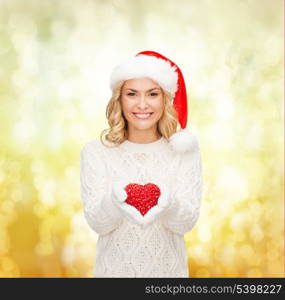 christmas, x-mas, winter, charity, love, happiness concept - smiling woman in santa helper hat with red heart