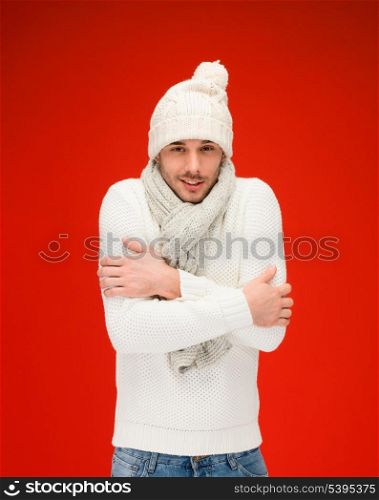 christmas, x-mas, winter, clothes concept - handsome man in warm sweater, hat and scarf