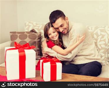 christmas, x-mas, winter, happiness and people concept - smiling father and daughter hugging