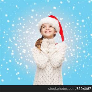 christmas, x-mas, winter, happiness concept - dreaming girl in santa helper hat