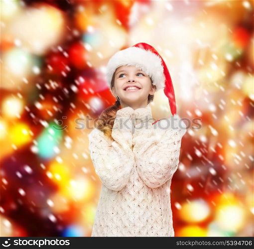 christmas, x-mas, winter, happiness concept - dreaming girl in santa helper hat