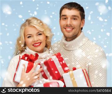 christmas, x-mas, winter, happiness concept - happy man and woman with many gift boxes