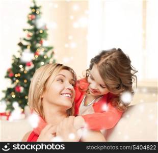 christmas, x-mas, winter, happiness concept - hugging mother and daughter