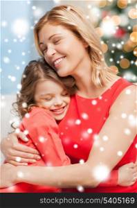 christmas, x-mas, winter, happiness concept - hugging mother and daughter
