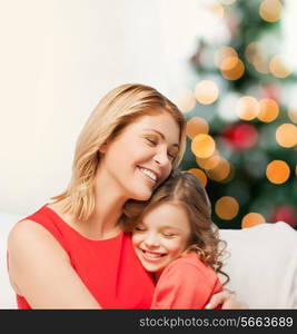 christmas, x-mas, winter, happiness concept - hugging mother and daughter