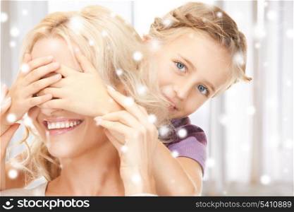christmas, x-mas, winter, happiness concept - mother and daughter making a joke