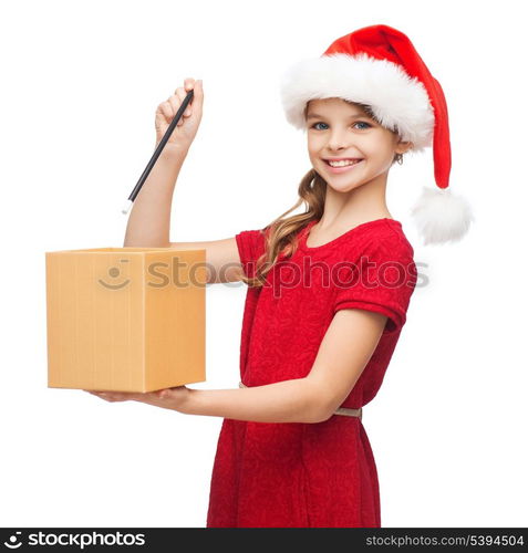 christmas, x-mas, winter, happiness concept - smiling girl in santa helper hat with gift box and magic wand