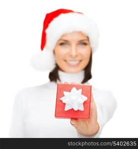 christmas, x-mas, winter, happiness concept - smiling woman in santa helper hat with small gift box