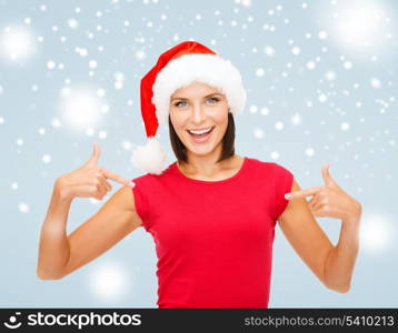 christmas, x-mas, winter, happiness concept - smiling woman in santa helper hat and red shirt