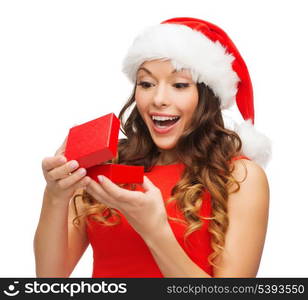 christmas, x-mas, winter, happiness concept - smiling woman in santa helper hat with gift box