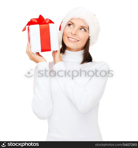 christmas, x-mas, winter, happiness concept - smiling woman in santa helper hat with gift box