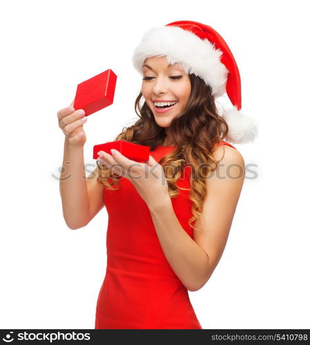 christmas, x-mas, winter, happiness concept - smiling woman in santa helper hat with gift box