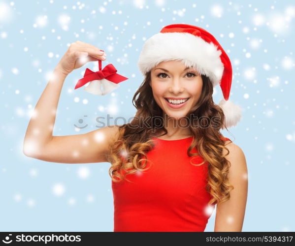 christmas, x-mas, winter, happiness concept - smiling woman in santa helper hat with jingle bells