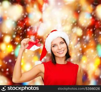 christmas, x-mas, winter, happiness concept - smiling woman in santa helper hat with jingle bells